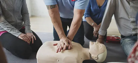Performing chest compressions on a CPR dummy